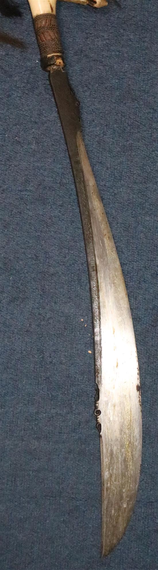 A Dayak stag horn-handled Mandau (head-hunters sword), wood scabbard, late 19th / early 20th century, total length 78.5cm (30.9in.)